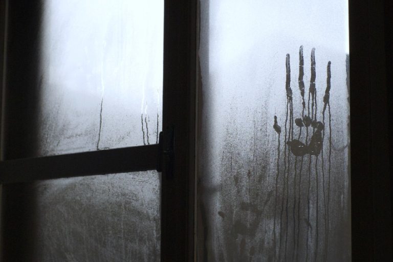 Hand on glass window